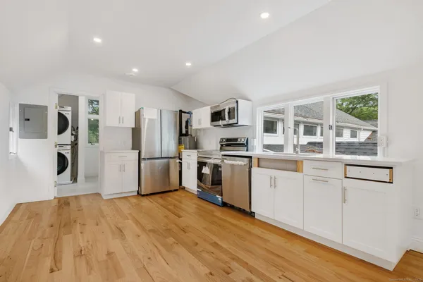 a kitchen with stainless steel appliances a refrigerator and a stove top oven