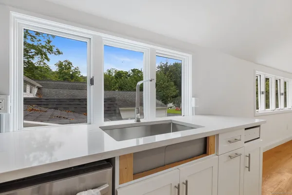 a view of a room that has a sink and a large window
