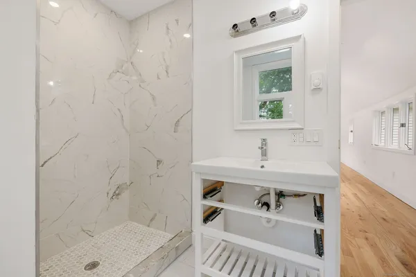 a bathroom with a sink a bathtub and a shower