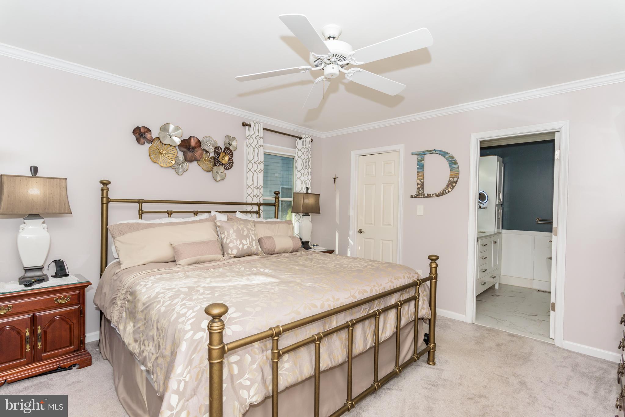 11 Drawbridge Road Berlin, MD 21811 - Photo 35 of 78 a bedroom with a bed and a chandelier