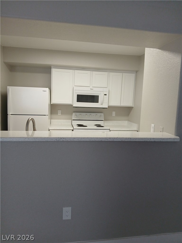 555 East Silverado Ranch Boulevard, Unit 1098 Las Vegas, NV 89183 - Photo 10 of 10 A well-appointed kitchen features ample counter space and essential appliances for daily living.