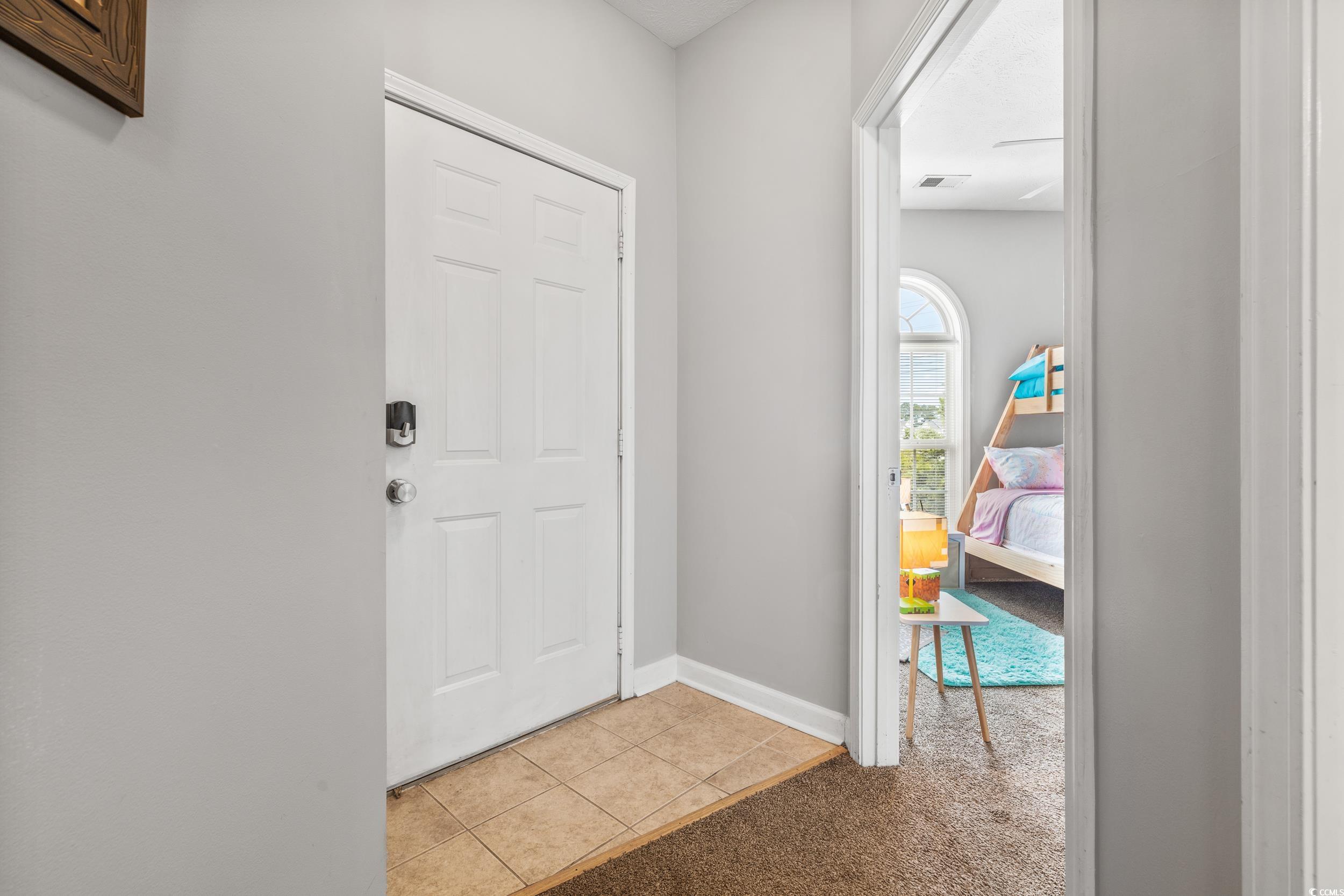 Hall with sink and carpet flooring