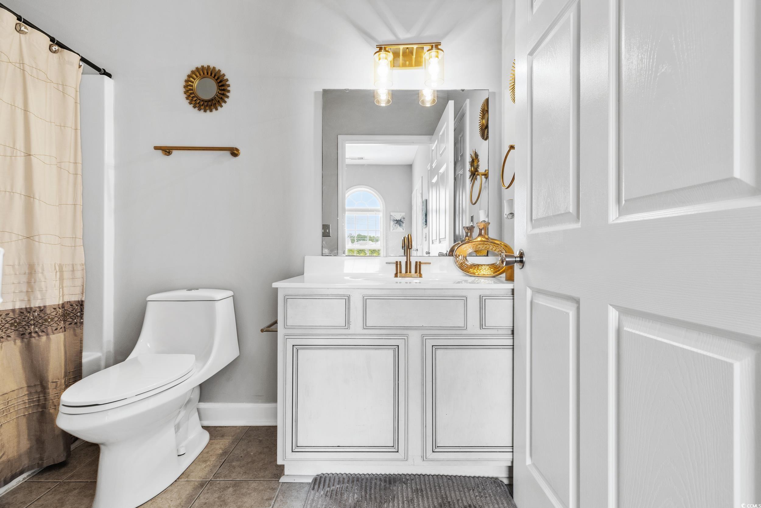 Bedroom with connected bathroom, light colored car