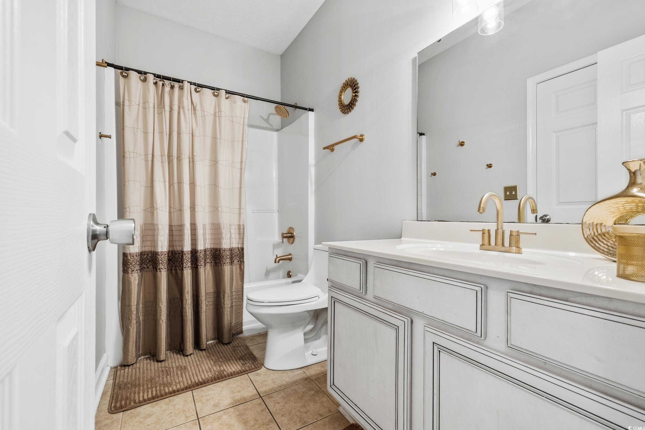 213 Wando River Road, Unit E Myrtle Beach, SC 29579 - Photo 8 of 28 Bathroom featuring vanity, tile patterned floors,