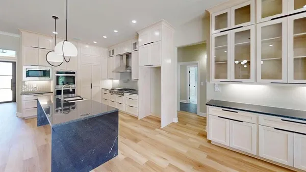 a view of cabinets and utility room with closet