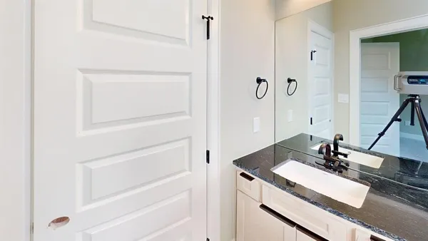 a bathroom with a double vanity sink a mirror and a bathtub