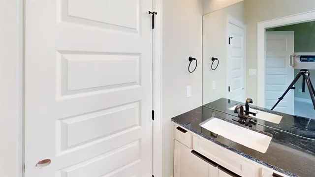 a bathroom with a double vanity sink a mirror and a bathtub
