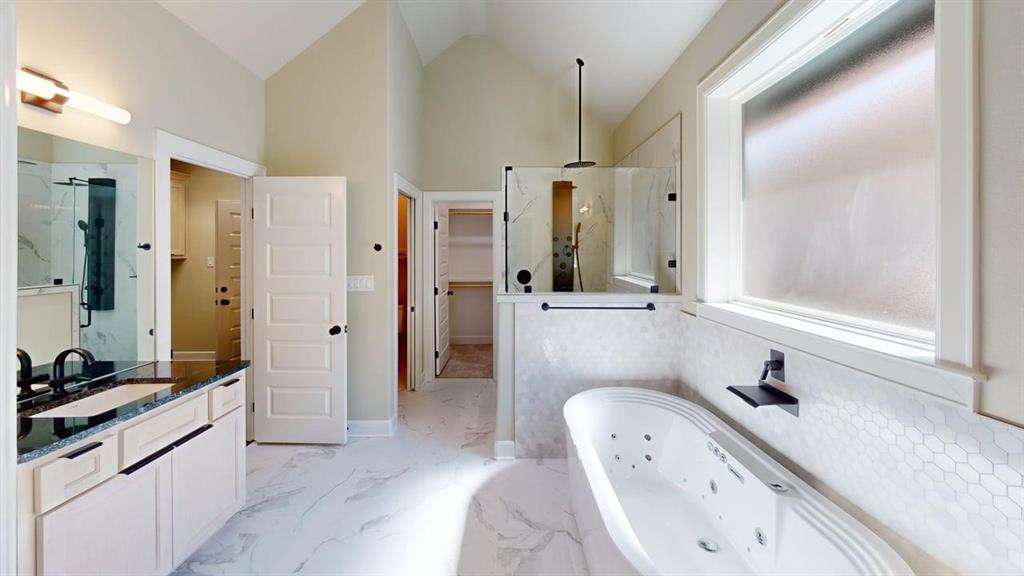 2510 Windmillln Windmill Lane Longview, TX 75601 - Photo 7 of 35 a bathroom with a double vanity sink a mirror and a bathtub