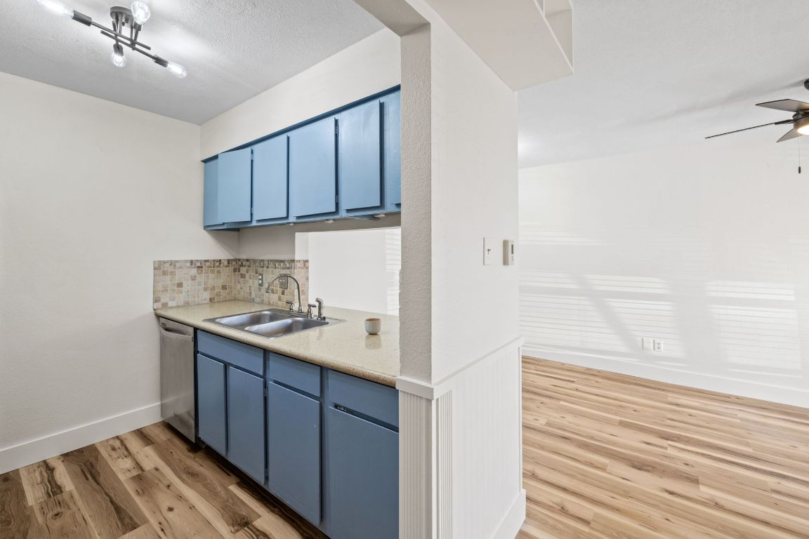 1705 Crossing Place, Unit 117B Austin, TX 78741 - Photo 14 of 33 a kitchen with a sink and cabinets