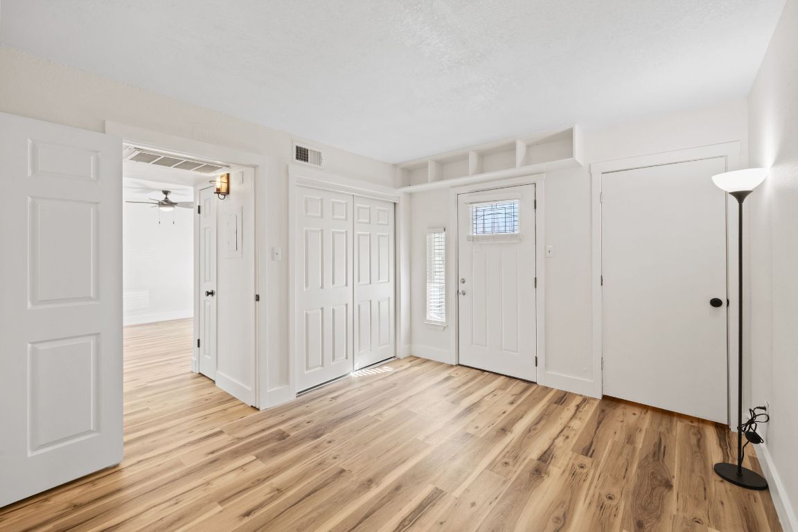 1705 Crossing Place, Unit 117B Austin, TX 78741 - Photo 17 of 33 a view of an empty room with wooden floor