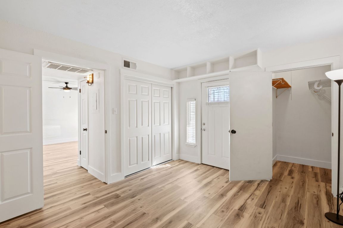 1705 Crossing Place, Unit 117B Austin, TX 78741 - Photo 18 of 33 a view of a room with wooden floor and closet