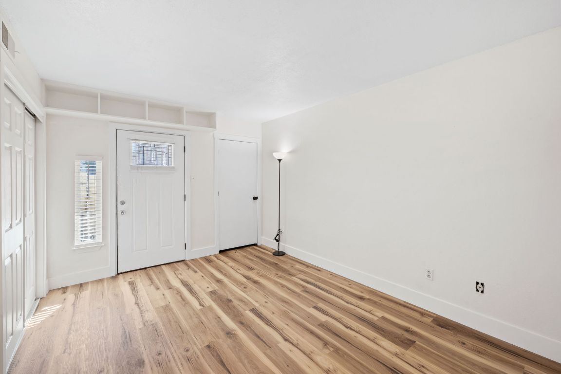 1705 Crossing Place, Unit 117B Austin, TX 78741 - Photo 20 of 33 a view of a room with wooden floor