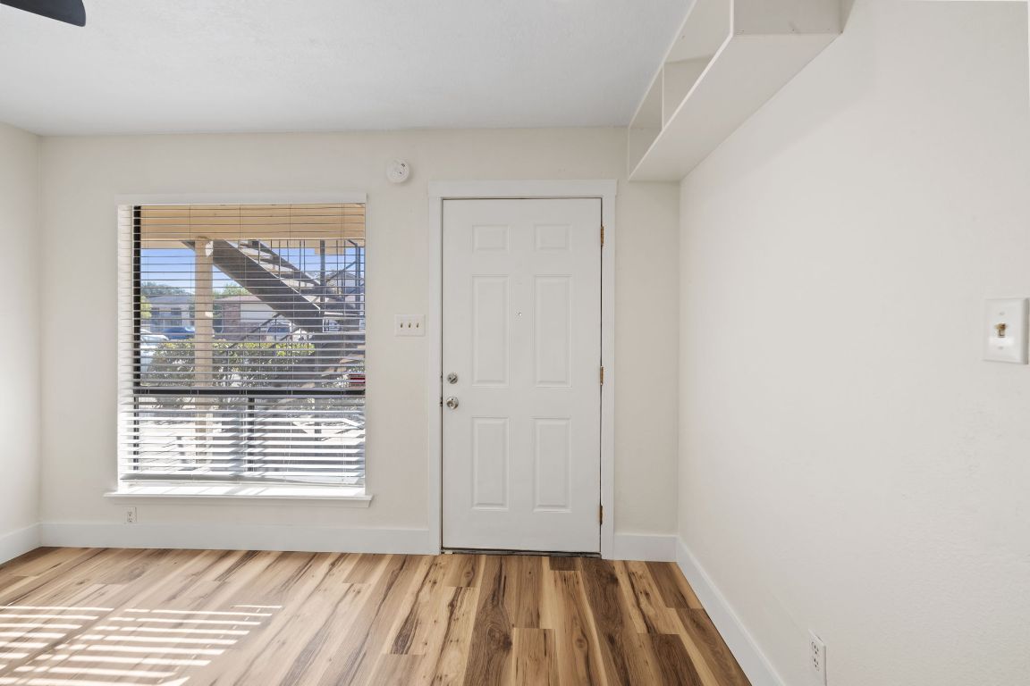 1705 Crossing Place, Unit 117B Austin, TX 78741 - Photo 7 of 33 a view of a room with wooden floor and windows