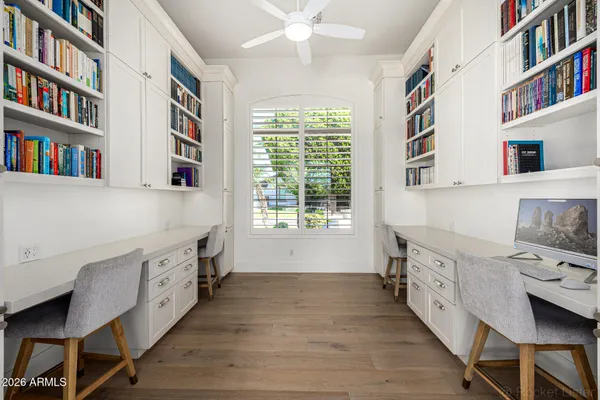 a living room with stainless steel appliances furniture and a kitchen view