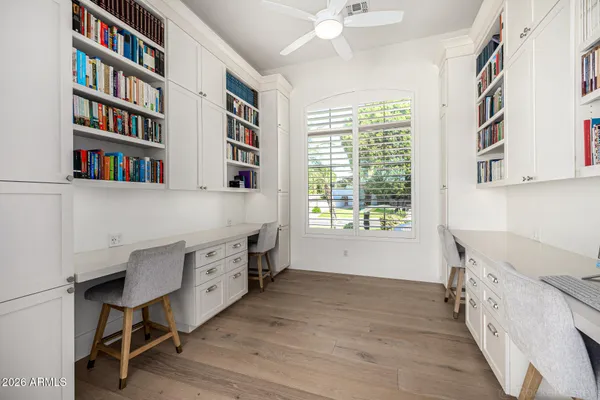 a kitchen with stainless steel appliances granite countertop a stove a sink and a refrigerator with wooden floor