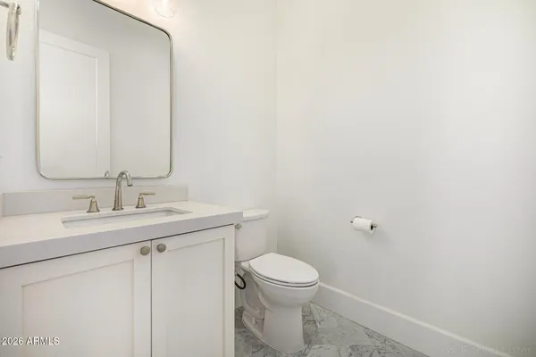 a kitchen with stainless steel appliances granite countertop a refrigerator a sink and a stove