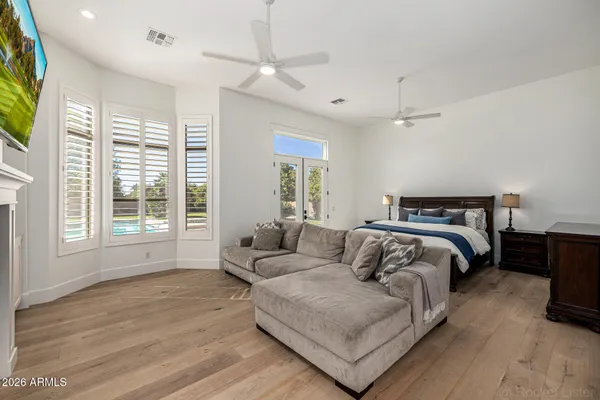 a living room with furniture and a ceiling fan