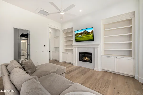 a living room with furniture ceiling fan and a couch