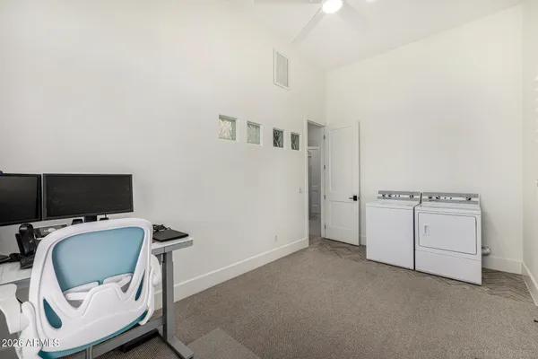 a bedroom with a bed and a ceiling fan