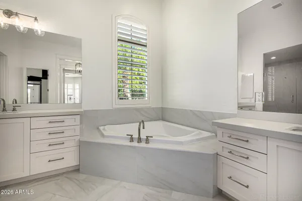 a view of swimming pool with lawn chairs and large trees