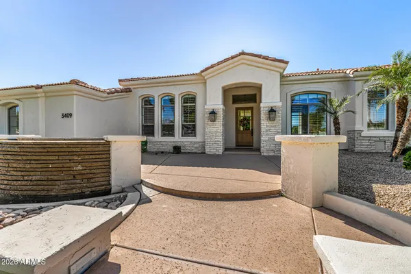 a living room with furniture chandelier and a window