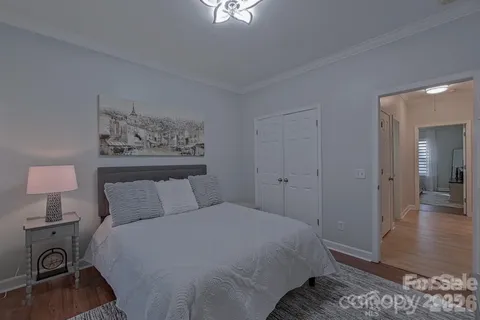 a bedroom with a bed and a lamp on table