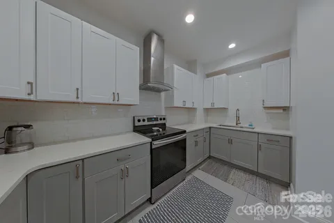 a kitchen with cabinets appliances and a sink
