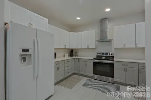 a kitchen with stainless steel appliances granite countertop a refrigerator sink and stove