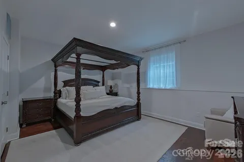 a bedroom with a bed and a potted plant