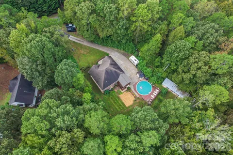 an aerial view of a house with a yard and outdoor seating
