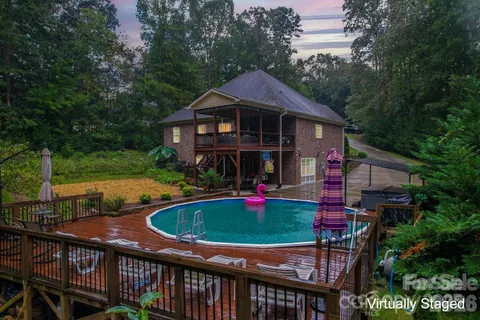 a front view of house with yard and trees in the background