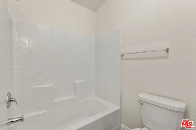 a white bath tub sitting next to a toilet
