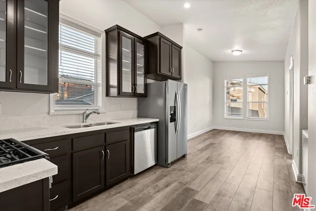 a kitchen with stainless steel appliances a refrigerator and a sink
