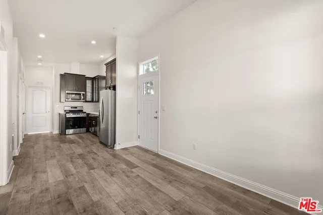 a view of kitchen with refrigerator and window
