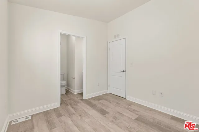 an empty room with wooden floor