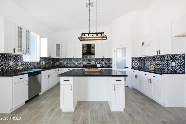 a view of a kitchen with a sink and a fireplace