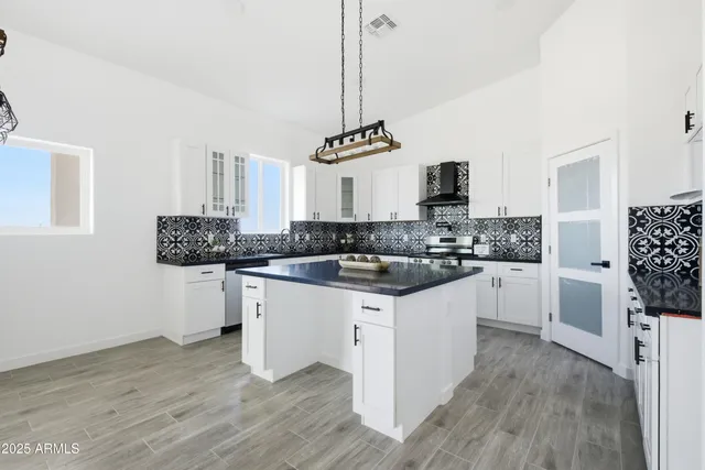 a kitchen with stainless steel appliances granite countertop a stove and cabinets