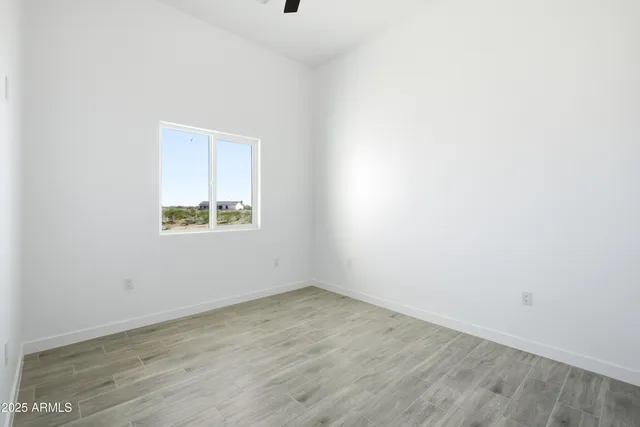 an empty room with wooden floor