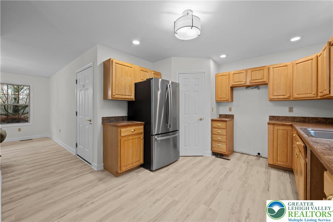 2 Pinewood Circle Hazleton, PA 18202 - Photo 11 of 34 a kitchen with a refrigerator a stove top oven a sink and dishwasher with wooden floor