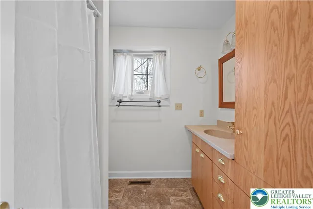 a bathroom with a sink a mirror and a vanity