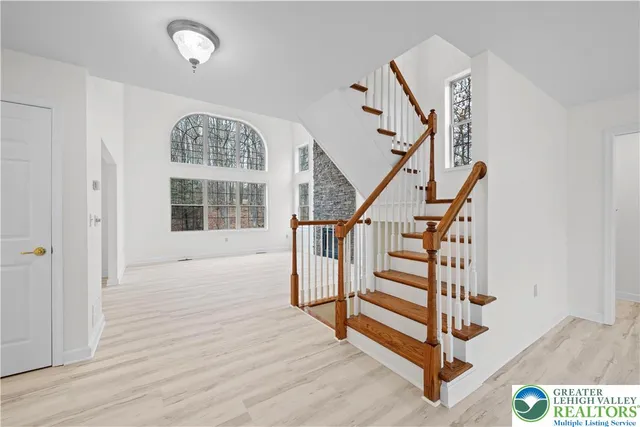 a view of entryway with stairs and wooden floor