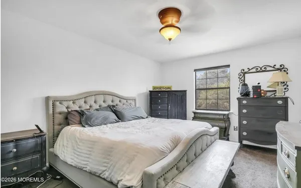 a bedroom with a bed and cabinet