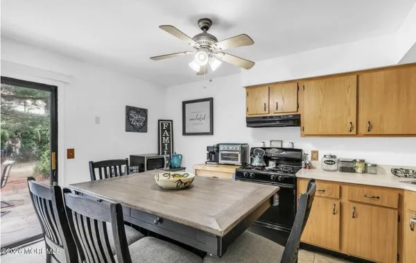 a kitchen with a table chairs stove and cabinets