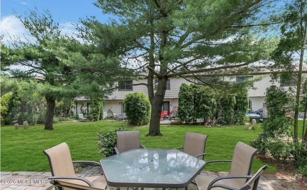 a view of a chair and table in the garden