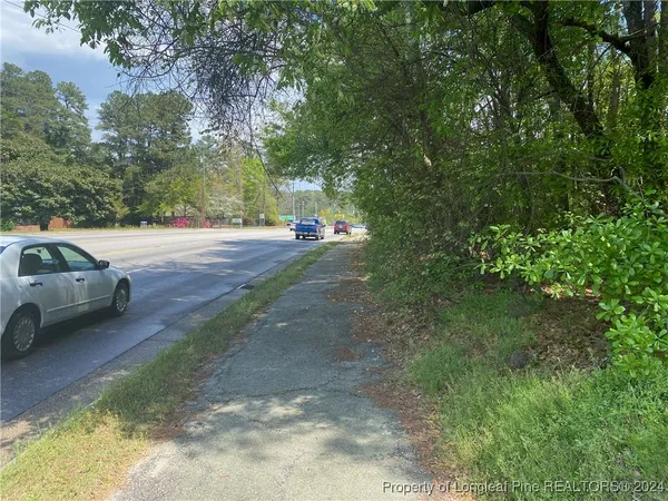 a view of a yard with car parked