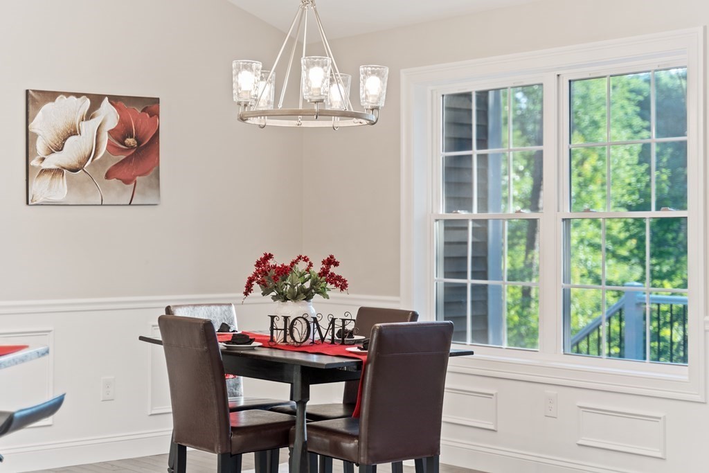 245 Glendale Road Northampton, MA 01062 - Photo 12 of 36 a view of a dining room with furniture a chandelier and wooden floor