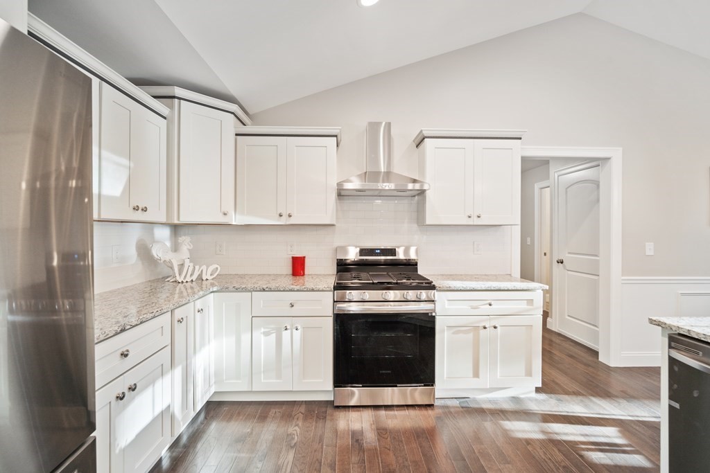 245 Glendale Road Northampton, MA 01062 - Photo 16 of 36 a kitchen with stainless steel appliances granite countertop a stove a sink and white cabinets with wooden floor