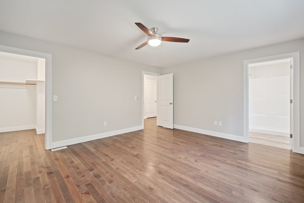 245 Glendale Road Northampton, MA 01062 - Photo 19 of 36 a view of an empty room with wooden floor and a ceiling fan