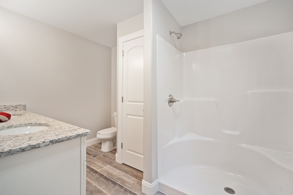 245 Glendale Road Northampton, MA 01062 - Photo 21 of 36 a bathroom with a granite countertop sink a toilet and shower