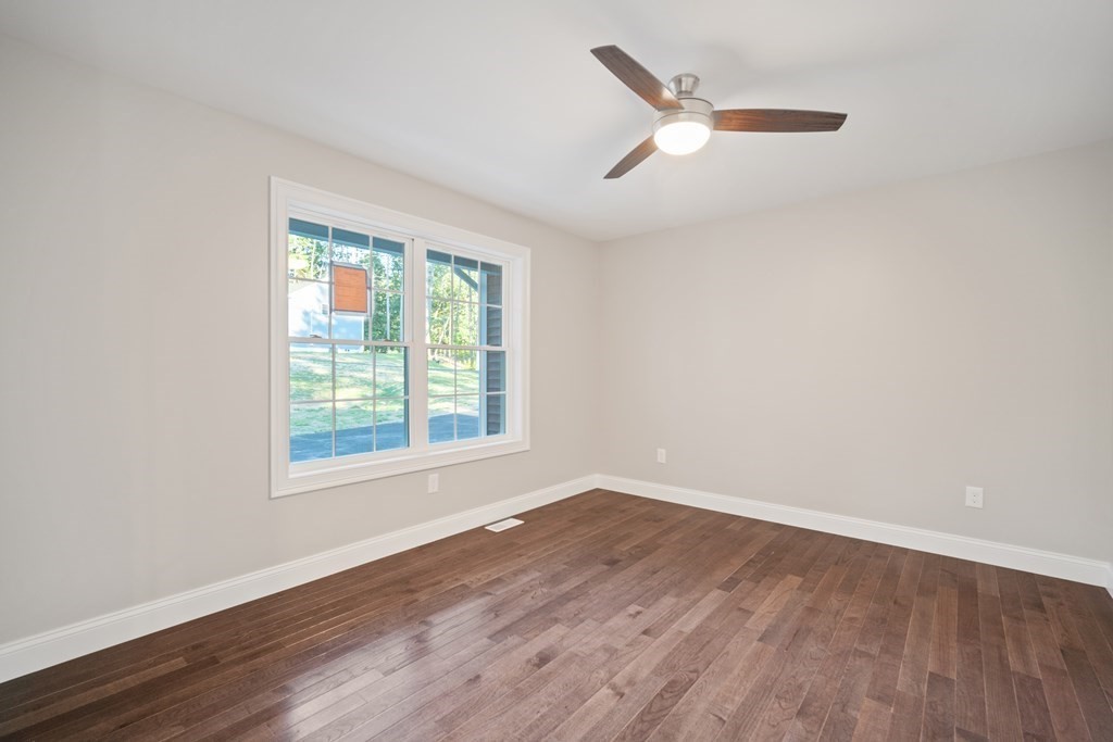 245 Glendale Road Northampton, MA 01062 - Photo 24 of 36 an empty room with wooden floor fan and windows